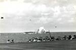 A Japanese special attack A6M aircraft crashing close aboard the starboard side of the carrier Ticonderoga off the Philippines, 5 Nov 1944. Photo 1 of 3.