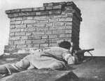 Polish resistance fighter positioning himself on a roof, Evangelic Cemetery, Wola District, Warsaw, Poland, 2 Aug 1944