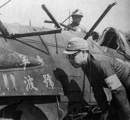 Japanese soldiers inspecting downed Chinese Hawk III fighter 'Ningbo Special' (No. 2503), Far East Stadium, Shanghai, China, Aug-Sep 1937