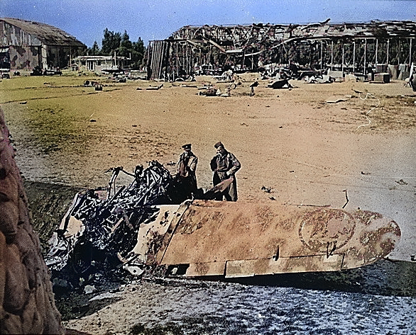 Wreckage of Italian hangars and aircraft, Castel Benito airfield outside Tripoli, Libya, late 1942 [Colorized by WW2DB]