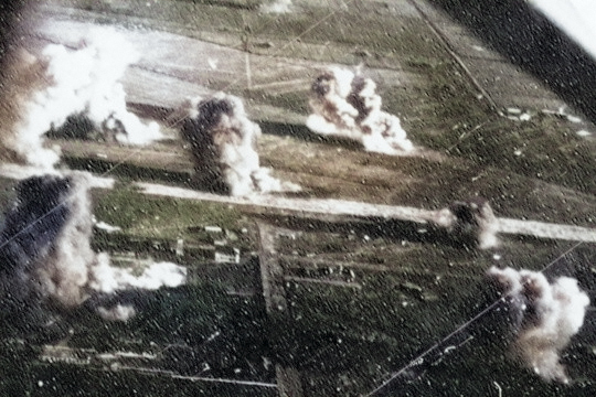 Carrier aircraft of Task Force 38 attacking the Japanese Army airfield at Takao (now Kaohsiung), Taiwan, 12 Oct 1944, photo 2 of 4; US intelligence referred to this field as 'Reigaryo Airfield' [Colorized by WW2DB]