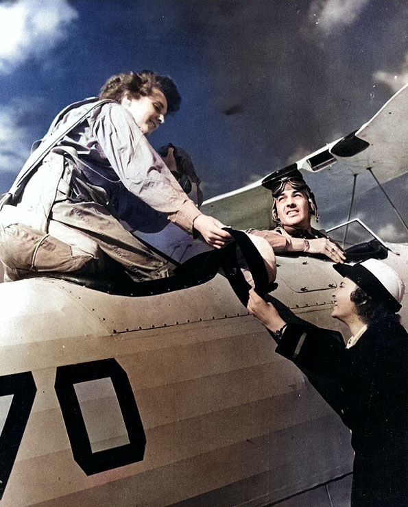 Ensign Mary McLean gave her hat to another WAVES officer as she boarded a training aircraft for an orientation flight, Naval Air Station, Squantum, Massachusetts, United States, Oct 1943 [Colorized by WW2DB]