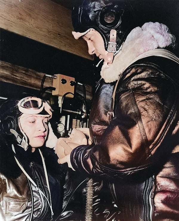 US Navy sailor helping a WAVES trainee pilot putting on her oxygen mask,  Naval Air Station, Jacksonville, Florida, United States, 15 Oct 1943 [Colorized by WW2DB]