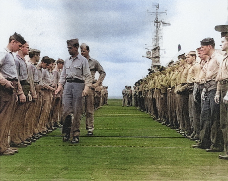 Ensign Richard Hansen (with Division Chief Kenneth Firestone) inspecting sailors aboard USS Anzio, 28 Apr 1945 [Colorized by WW2DB]
