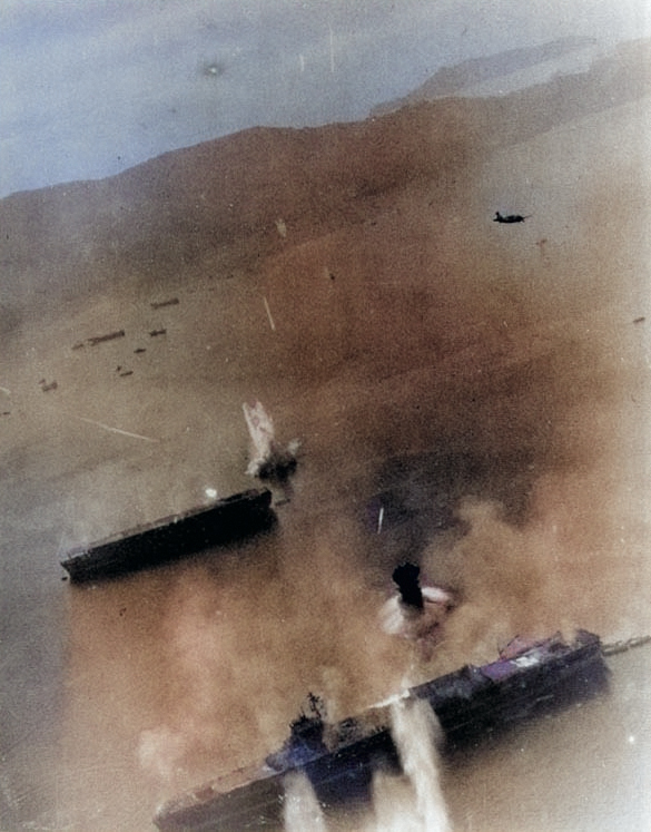 Kaiyo (center) under attack by SB2C Helldiver bombers from USS Essex, Kure, Japan, 19 Mar 1945; the carrier at bottom was either Amagi or Katsuragi [Colorized by WW2DB]