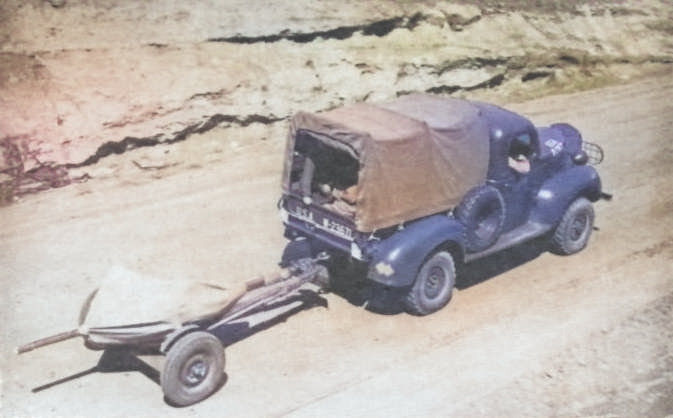 37 mm Gun M3 being towed by a truck, circa 1941 [Colorized by WW2DB]