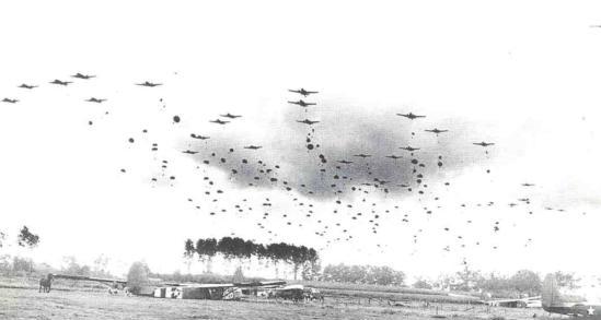 C-47 Skytrain aircraft of US 315th Troop Carrier Group dropping 41 sticks of 1st Polish Airborne Brigade into Graves, the Netherlands, 23 Sep 1944; note CG-4A gliders already on the ground