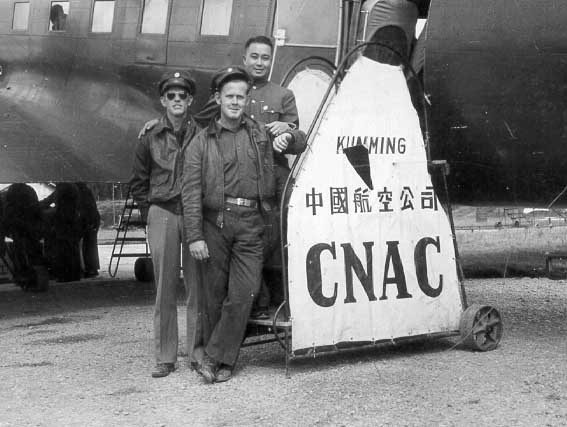 CNAC pilot Erik Shilling (left), copilot (front), and radio operator (Chinese man, rear) with their C-53 Skytrooper aircraft belonging to the China National Aviation Corporation, Kunming, Yunnan Province, China, 1940s