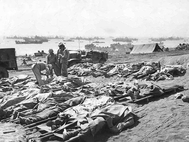 Dead Marines of the US 3rd Marine Division, covered by ponchos, Iwo Jima, Japan, Feb-Mar 1945