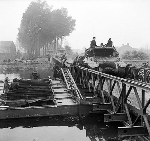 M10 Wolverine tank destroyers of 77th Anti-Tank Regiment, British 11th Armored Division crossing a Bailey bridge over the Meuse-Escaut (Maas-Schelde) Canal at Lille St Hubert, Belgium, 20 Sep 1944