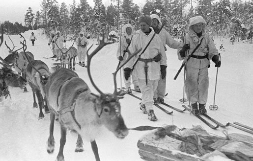 Finnish soldiers on skis with reindeers, near Jäniskoski, Finland, 20 Feb 1940