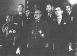 Thai special envoy Phot Phahonyothin (front row, first from left), Japanese Prime Minister Hideki Tojo (front row, center), Thai Minister Direk Jayanama (front row, first from right), and Thai Minister Thawan Thamrongnavaswadhi (second row, to left of Tojo in the photograph), Tokyo, Japan, 1942
