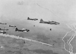 B-17G Fortresses of the 546th Bomb Squadron drop their loads on the rail yards at Elsterwerda, Germany, Apr 19 1945. Note the smoke marker dropped by the lead aircraft signaling the remaining aircraft to drop their bombs.