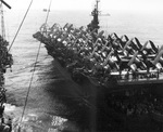 Escort Carrier USS Attu and Fleet Carrier USS Shangri-La (left) exchanging personnel and equipment by high wire while at sea, 3 Sep 1945. Note F4U Corsairs and SB2C Helldiver aircraft on Attu’s deck.