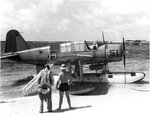 OS2U Kingfisher at the edge of the seaplane ramp at NAS Pensacola, Florida, United States, early 1941. Note Consolidated P2Y flying boat laying off shore, photo 1 of 2 (b/w)