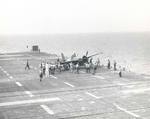 An FM-2 Wildcat appears to have damaged its landing gear in a hard landing aboard the training aircraft carrier USS Sable on Lake Michigan, United States, 1944-45.