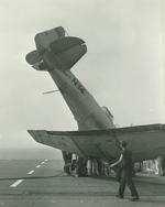 An SNJ-3C Texan noses over just before reaching the edge of the flight deck aboard the training aircraft carrier USS Wolverine on Lake Michigan, United States, 1943.