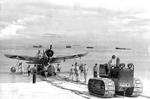 An OS2U Kingfisher float plane being towed ashore at Funafuti, Ellice Islands, mid to late 1942. Note the extremely oversized insignia on the wings.