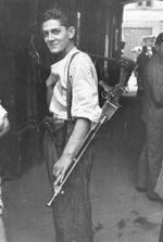 Polish resistance fighter, Warsaw, Aug 1944; note ZB vz. 26 light machine gun at shoulder and unidentified pistol in holster