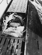 Photograph of a damaged German torpedo lodged in the deck works of the captured U-505 before United States Navy ordinancemen removed it and jettisoned it, 9 Jun 1944