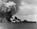 USS Franklin on fire and suffering more explosions after being hit by a Japanese bomb off Japan, 19 Mar 1945. Franklin would survive but only barely.