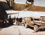 Air evacuation of wounded men from the Philippines on a mid-Pacific stop over, mid-1945. The wounded men are transferred from a PB2Y-3 Coronado to WC54 ambulances before boarding another plane bound for the US.