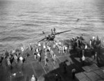 F6F-5 Hellcat BuNo 71632 being “surveyed” over the side of USS Hancock after flipping onto its back from a barrier crash on landing following a strike against Iwo Jima, 21 Feb 1945. The pilot was not hurt.
