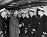 Secretary of the Navy Frank Knox greeting officers aboard the carrier USS Saratoga, circa 1943.