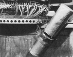 Close up of a Japanese 5kg Type A incendiary bomb hanging from a ballast ring of a Fu-Go balloon bomb, mid-1945. Note the two blowout plugs in the ballast ring supporting this bomb.