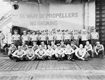 Enlisted personnel of Torpedo Squadron VT-27 in front of the scoreboard for USS Princeton (Independence-class), Western Pacific, late 1944.
