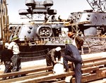 Guns and other topside weight being removed from the damaged cruiser USS St. Louis before removing the damaged bow section altogether, Sep 1943, Mare Island Naval Shipyard, Vallejo, California, United States.