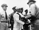 Rear Admiral Walden Ainsworth, right, presenting the Navy and Marine Corps Medal to Aviation Radiomans Mate 3rd class Russell Evintude aboard cruiser USS Santa Fe, circa 1945.