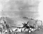 Crew of USS Oriskany fighting a fire caused by a F4U-4 Corsair fighter landing accident, off Korea, 6 Mar 1953