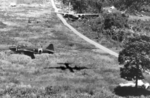 USAAF A-20 Havoc aircraft attacking a Japanese airfield at a low altitude, Lae, New Guinea, circa 1943; note G4M bomber on the ground