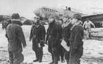 Japanese airmen on a snowy airfield, circa 1940s; note Ki-32 aircraft in background