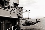 US Navy PBM-5 Mariner aircraft being hoisted onto a seaplane tender, early 1950s