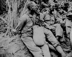 Americans prisoners, with hands tied behind their backs, caught a rare moment of rest on the Bataan Death March, Luzon, Philippine Islands, May 1942