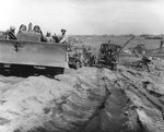 Bulldozer, Jeep, and other vehicles on an Iwo Jima beach, circa late Feb or early Mar 1945