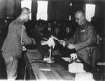 Haruki Isayama handing the surrender document bearing Rikichi Ando