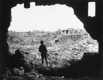 A US Marine observing ruined buildings in Naha, Okinawa, Japan, 13 Jun 1945