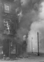 Burning residential building at the intersection of Zamenhofa and Wolynska Streets in Warsaw, Poland, Apr-May 1943