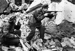 Polish resistance fighters Henryk Ozarek (with Vis pistol) and Tadeusz Przybyszewski (with Blyskawica submachine gun) of Anna Company of Gustaw Battalion fighting on Kredytowa-Krolewska Street, Warsaw, Poland, Oct 1944