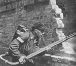 Polish resistance fighter with K pattern flamethrower near the Mała Pasta building, Warsaw, Poland, 22 Aug 1944