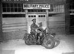 An African-American military policeman posing on his motorcycle in Columbus, Georgia, United States, 13 Apr 1942