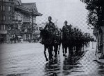 Japanese Army cavalrymen from the Nara garrison near the present day intersection of Showa Dori and Harumi Dori, Tokyo, Japan, 1938; note the Kabuki-za building in background