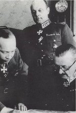 Carl Gustaf Emil Mannerheim and Aksel Airo studying a map, Finland, circa 1941-1944; Erik Heinrichs in background