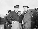 Dwight Eisenhower and Lucius Clay at the airfield in Gatow, Berlin, Germany, 20 Jul 1945; note Omar Bradley in background
