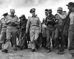 Rear Admiral Burke surrounded by journalists after the Kaesong cease fire talks, Korea, 12 Jul 1951