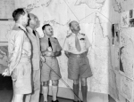 Lieutenant General Gordon Bennett discussing strategy with RAN Commodore C. J. Pope, USN Captain A. R. McCann, and RAAF Air Commodore R. J. Brownell, Australia, Feb 1943
