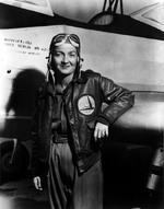 Nancy Harkness Love posing in front of a PT-19A trainer aircraft, 1942-43. Note WAFS patch on her jacket (forerunner of the WASPs).